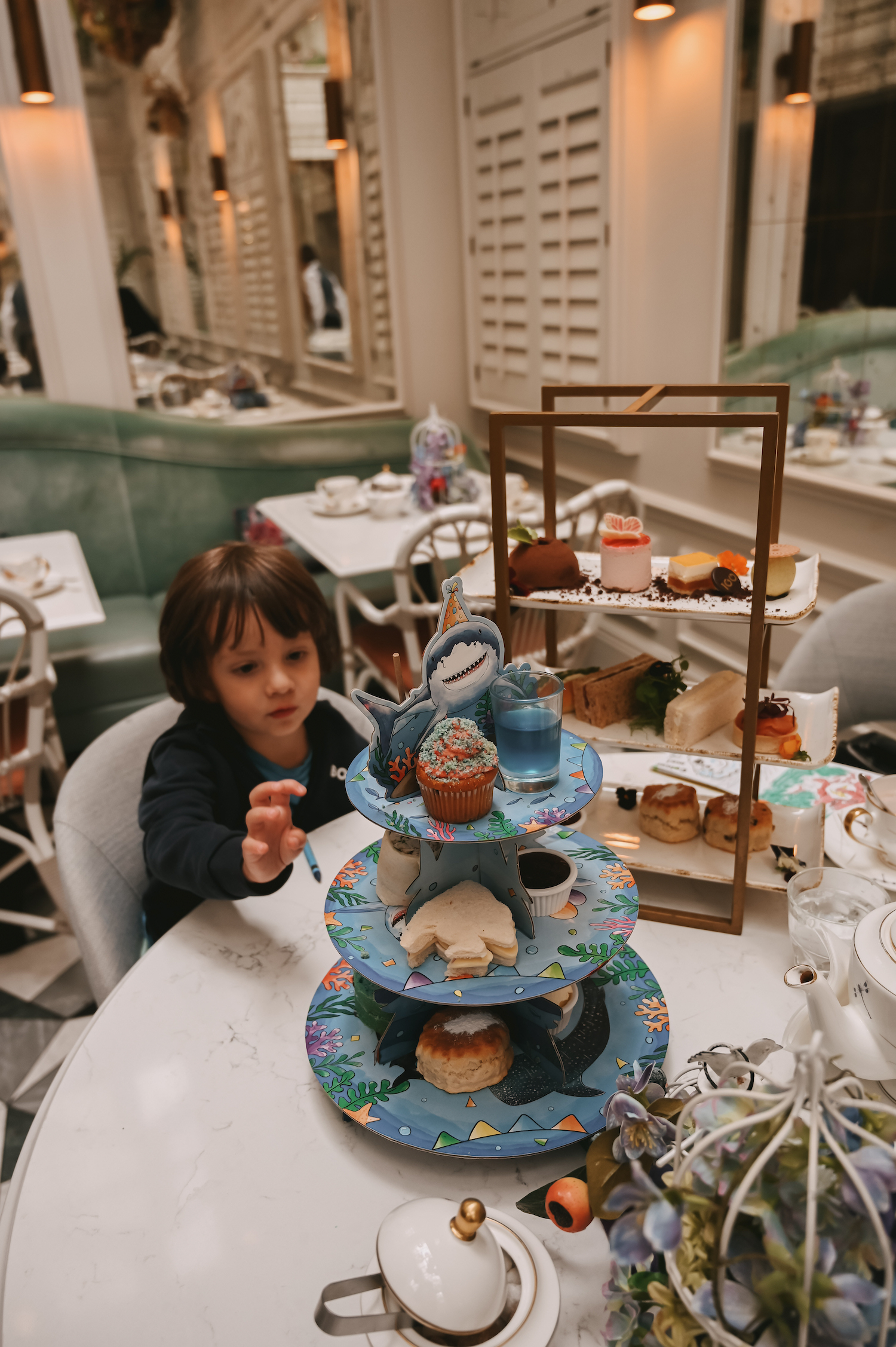 child enjoying under the sea themed afternoon tea Sea & Scones at 100 Queen's Gate. 