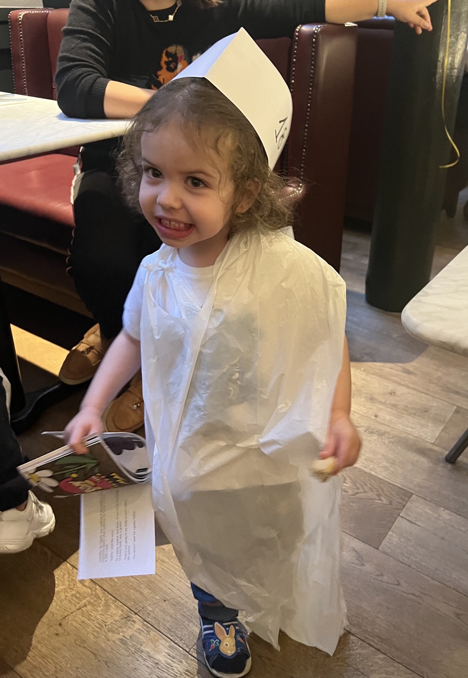 Small child in a chef's hat at a Pizza Express party