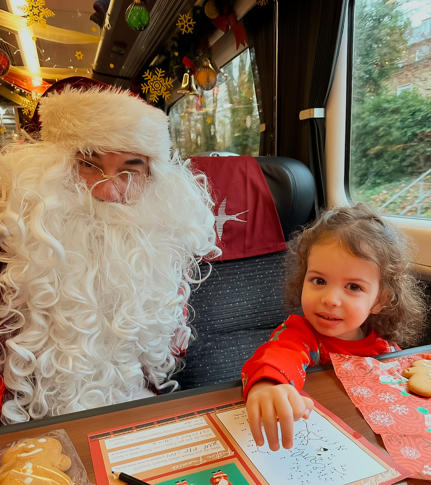 Small child meeting santa on the Steam Dreams train