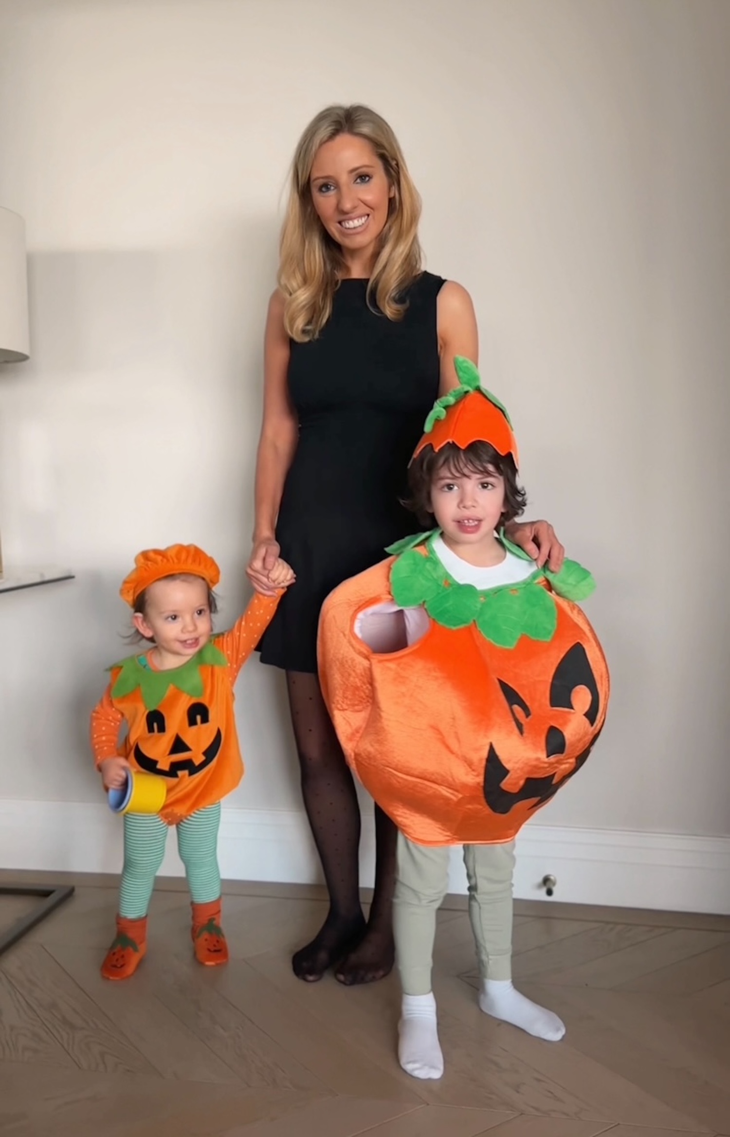 Mum with two kids dressed as pumpkins